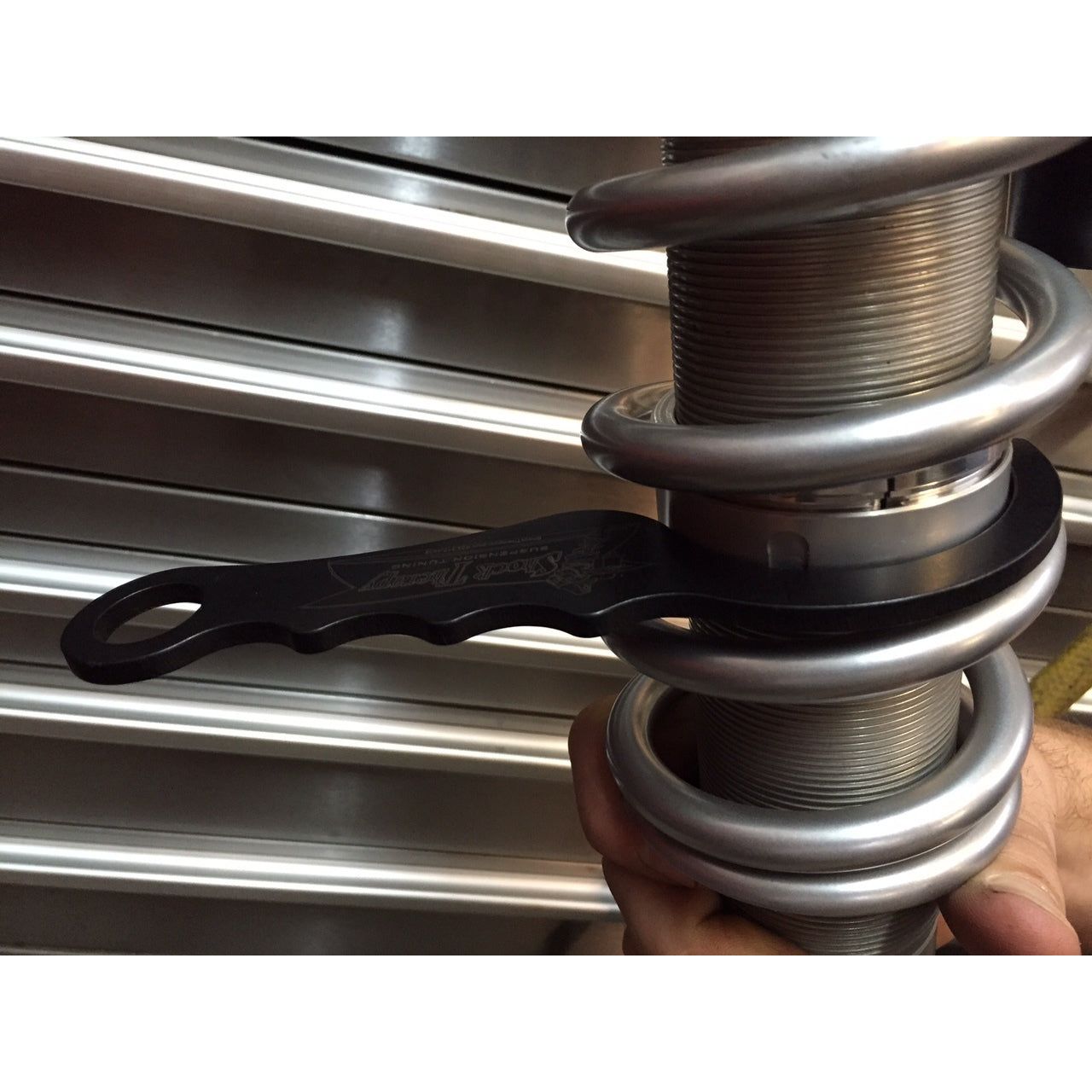 Adjust the cross over with the spring in place.